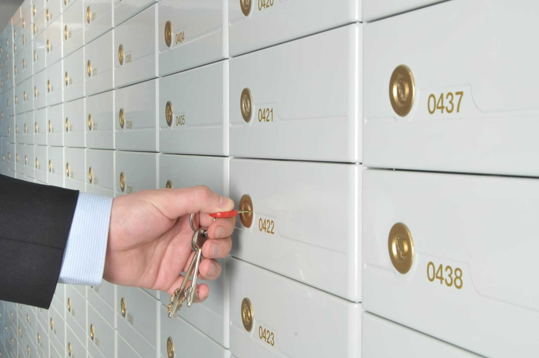 person unlocking a safe deposit box